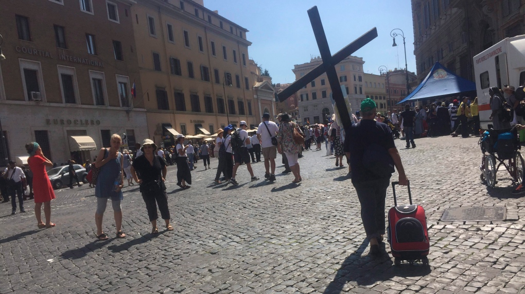 A pilgrim carrying a cross 
