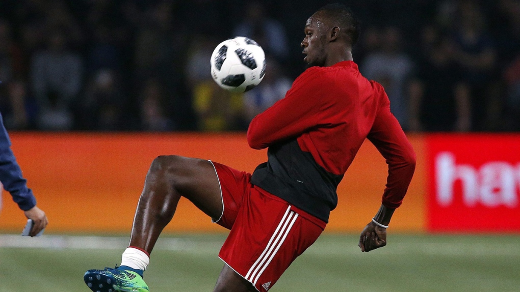 Usain Bolt controls the ball during training