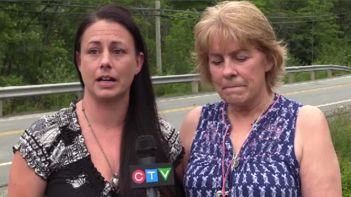 Kylie Cooper's mother Marlene Cooper (left) and grandmother Kathy Best at the scene of the crash where the cross was returned, but in a location further back from the road.