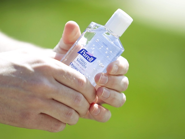 A reporter holds a bottle of hand sanitizer at a news conference about the confirmed cases of Influenza A (H1N1) at the training depot in Regina, Sask., on Friday, June 12, 2009.  (Troy Fleece / THE CANADIAN PRESS)