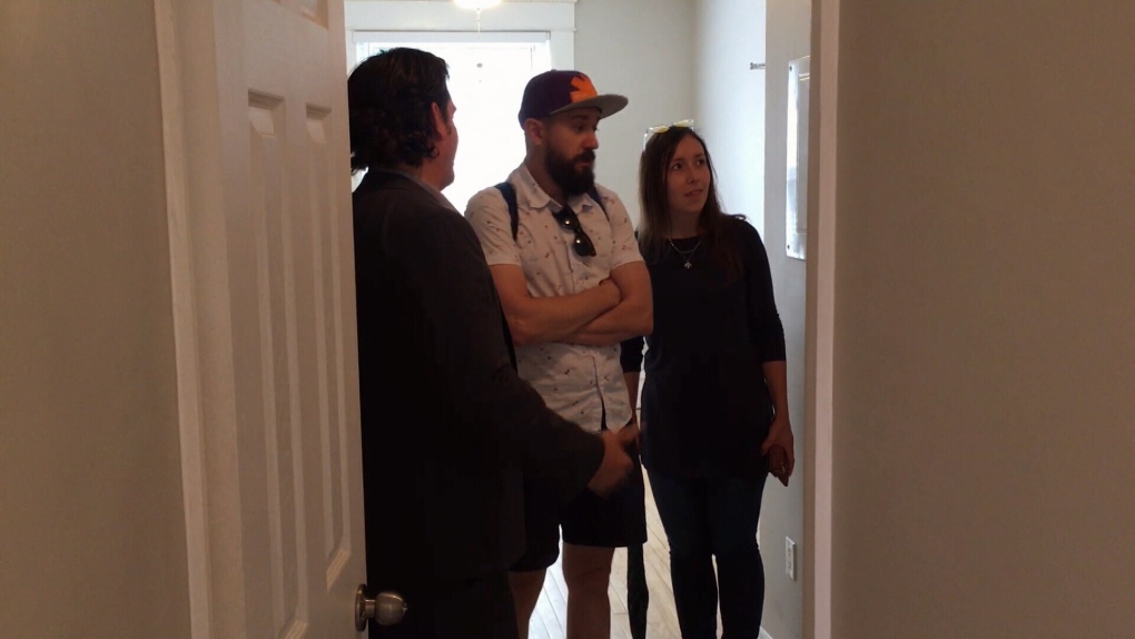 Potential tenants check out apartment with broker.