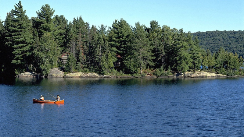 People canoe in Algonquin Provincial Park in Ontario, Canada, in this 2001 photo. (Algonquin Park / Ontario Tourism via The Canadian Press)