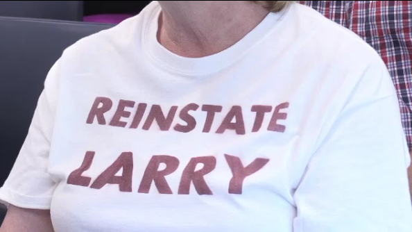 Protester wearing a Reinstate Larry shirt 