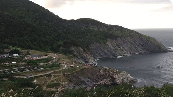 First responders from two volunteer fire departments helped rescue a woman who drove a motorcycle off this cliff in Meat Cove, N.S. After paramedics gave her first aid, she was transported by civilian boat (lower right) to Bay St. Lawrence. From there, an ambulance took to a local hospital before she was flown by helicopter to Halifax. (SUBMITTED)