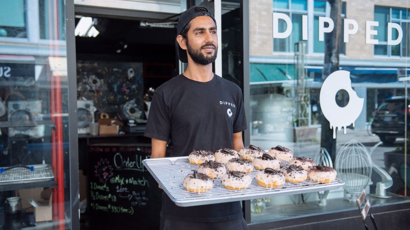 Jiten Grover, owner of Dipped Donuts, displays a new batch of donuts after nearly selling out by the afternoon in Toronto, Wednesday, September 12, 2018. THE CANADIAN PRESS/Galit Rodan