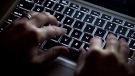 A woman types on a keyboard in Vancouver on Wednesday, December, 19, 2012. THE CANADIAN PRESS/Jonathan Hayward