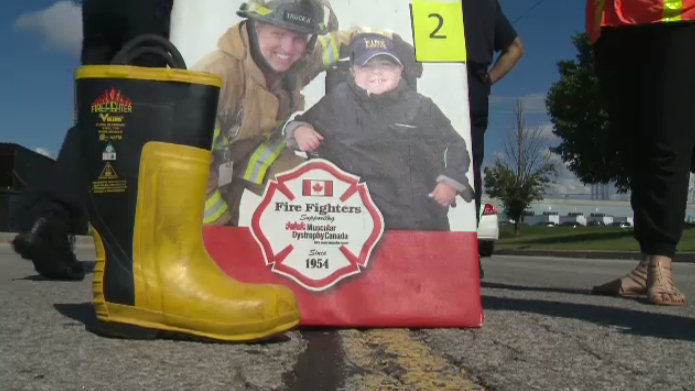 A fire fighter's boot next to a poster