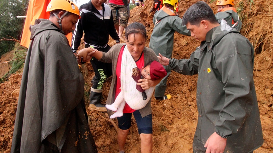 Rescuers assist a mother and her child 