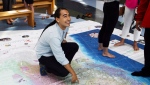 A visitor explores a giant floor map created for the launch of Canadian Geographic’s Indigenous Peoples Atlas of Canada.