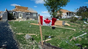 A Canadian flag flies in front of homes destroyed by a tornado in Dunrobin, Ont., west of Ottawa, on Saturday, Sept. 22, 2018. The storm tore roofs off of homes, overturned cars and felled power lines in the Ottawa community of Dunrobin and in Gatineau, Que. THE CANADIAN PRESS/Justin Tang