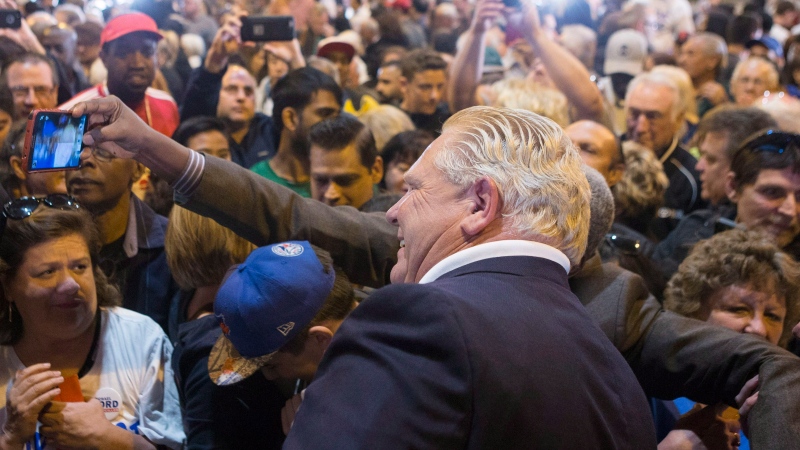 Ontario Premier Doug Ford poses for a selfie with a supporter after speaking at Ford Fest in Vaughan, Ontario, on Saturday September 22, 2018. Event organizers say the annual barbecue is expected to be bigger than ever with Doug Ford as premier. (THE CANADIAN PRESS / Chris Young)