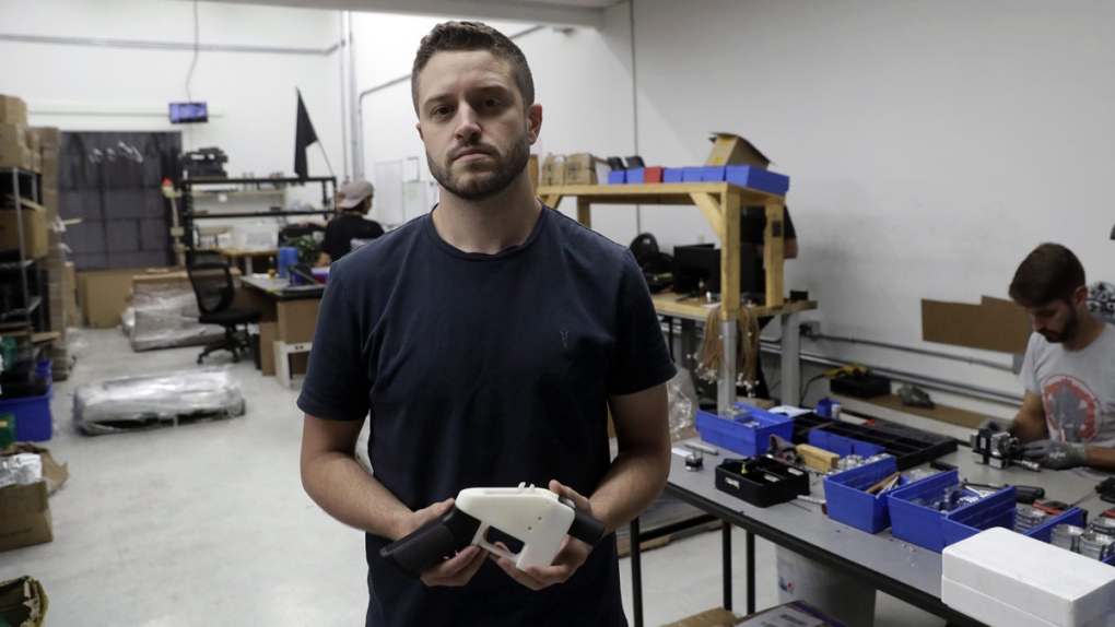 Cody Wilson holds a 3D-printed gun
