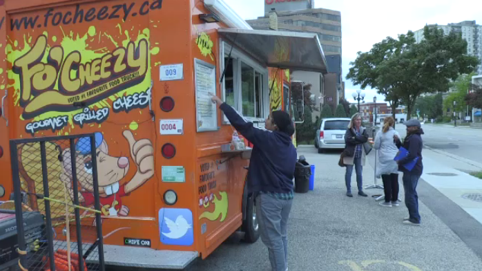 A person ordering at Fo'Cheezy food truck