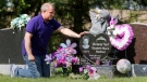 Rodney Stafford, father of slain Victoria (Tori) Stafford puts his hand on Victoria's grave marker, after the sentencing of Michael Rafferty who was found guilty on all three charges at the murder trial in London, Ontario, Tuesday, May 15, 2012. THE CANADIAN PRESS/Dave Chidley