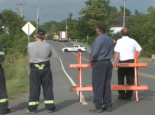 EMS officials block the area where four people were found dead in Kingston, Ont., Tuesday, June 30, 2009.