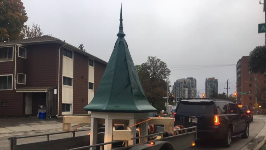 A restored cupola being moved back to its church