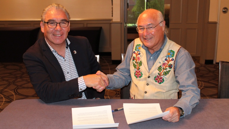 Glooscap First Nation Chief Sidney Peters, co-chairman of the Assembly of Nova Scotia Mi'kmaq Chiefs, and Clement Chartier, president of the Metis National Council, right, shake hands after signing a memorandum of understanding, in Halifax in a Wednesday, Oct. 3, 2018, handout photo. (THE CANADIAN PRESS/HO-Mi'kmaq Rights Initiative)