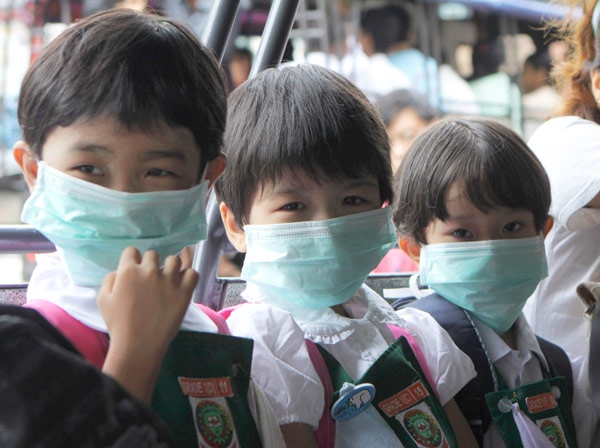 School children wear face masks as they line up to enter a classroom in Rangoon, Burma on Tuesday, June 30, 2009. (AP / Khin Maung Win)
