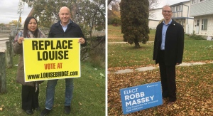 Incumbent councillor for Elmwood-East Kildonan Jason Schreyer (right) and Robb Massey pose with campaign signs. (Beth Macdonell/ CTV Winnipeg)