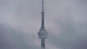 The CN Tower hides behind the clouds during a foggy morning in Toronto on Wednesday, June 27, 2018. THE CANADIAN PRESS/Tijana Martin