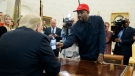 Rapper Kanye West shows President Donald Trump a photograph of a hydrogen plane during a meeting in the Oval Office of the White House, Thursday, Oct. 11, 2018, in Washington. (AP Photo/Evan Vucci)