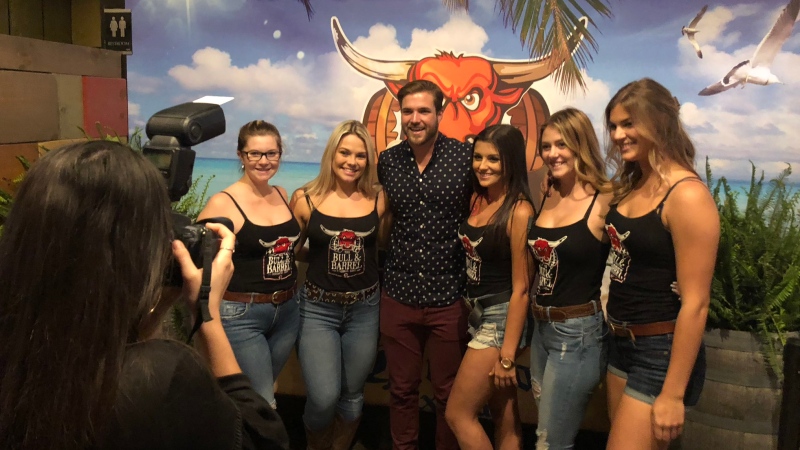 Bachelor Jordan Kimball poses with staff at the Bull and Barrel in Windsor, Ont., on, Thursday, Oct. 12, 2018. (Melanie Borrelli / CTV Windsor)