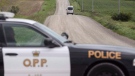 An Ontario Provincial Police van drives down a country road near Clinton, Ont., on Sunday, September 14, 2014. (THE CANADIAN PRESS/ Geoff Robins)