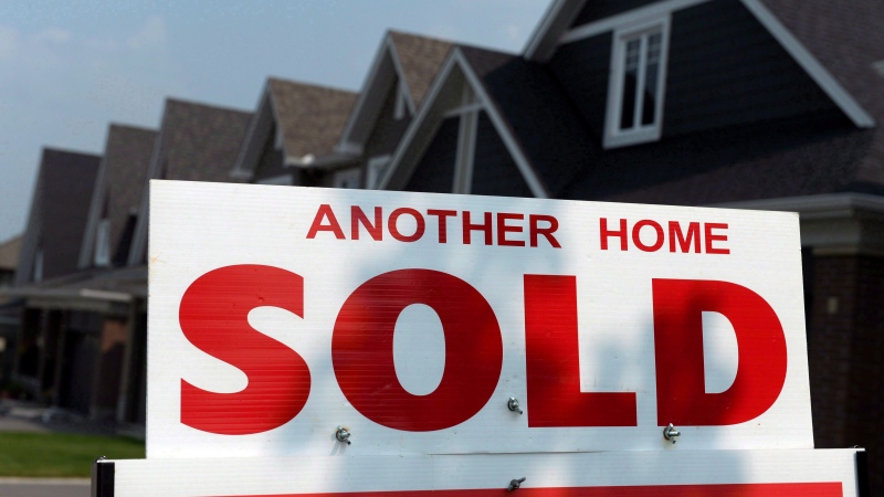A for sale sign displays a sold home in a development in Ottawa on July 6, 2015. (THE CANADIAN PRESS / Sean Kilpatrick)