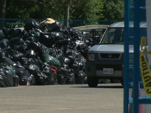 Garbage piles up at a temporary dump site near Leslie Street and Eglinton Avenue on Saturday, July 4, 2009.