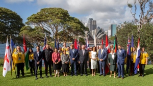 Britain's Prince Harry, center, and his wife Meghan, the Duchess of Sussex, center right, meet the Australian Governor-General Sir Peter Cosgrove and Lady Cosgrove, and representatives of Invictus Games participating countries in Sydney, Tuesday, Oct. 16, 2018. Prince Harry and his wife Meghan are on a 16-day tour of Australia and the South Pacific. (AP Photo/Steve Christo, Pool)