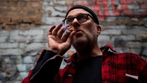 Jimson Bienenstock smokes a joint during a "Wake and Bake" legalized marijuana event in Toronto on Wednesday, Oct. 17, 2018. THE CANADIAN PRESS/Christopher Katsarov