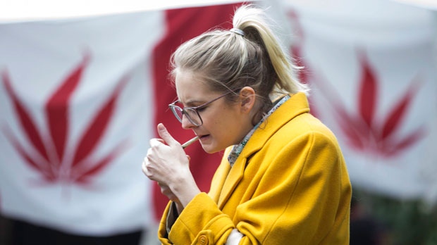 A woman smokes cannabis in a Toronto park on Wednesday, October 17, 2018, as they mark the first day legalization of Cannabis across Canada. (THE CANADIAN PRESS/Chris Young)