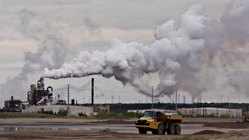 A dump truck works near the Syncrude oil sands extraction facility near the city of Fort McMurray, Alta., on June 1, 2014. THE CANADIAN PRESS/Jason Franson