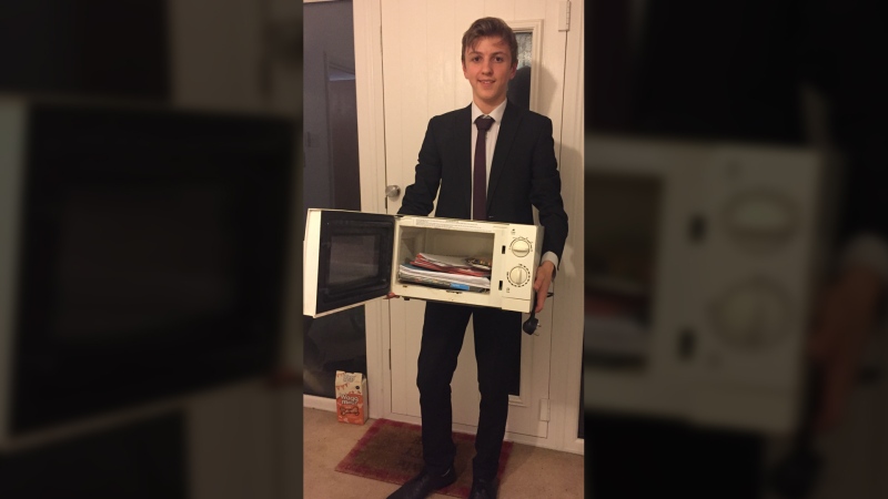 U.K. teen Jacob Ford carried his school materials in a microwave to protest his high school’s ban on carrying backpacks in the hallways. (Courtesy of Jacob Ford)