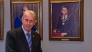 Gordon Krantz stands beside a photograph of his younger self after being re-elected mayor of Milton. 