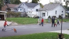 An officer in uniform joined a game of street hockey in Windsor, Ont. (Courtesy Jerry Gervais)