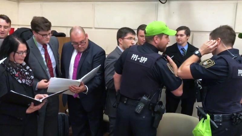 Parliament Hill security are seen speaking with Conservative MPs and staff who interrupted a NATO parliamentary association meeting by singing, in protest of the ousting of a floor-crossing MP as chair. (Peter Schiefke / Facebook) 