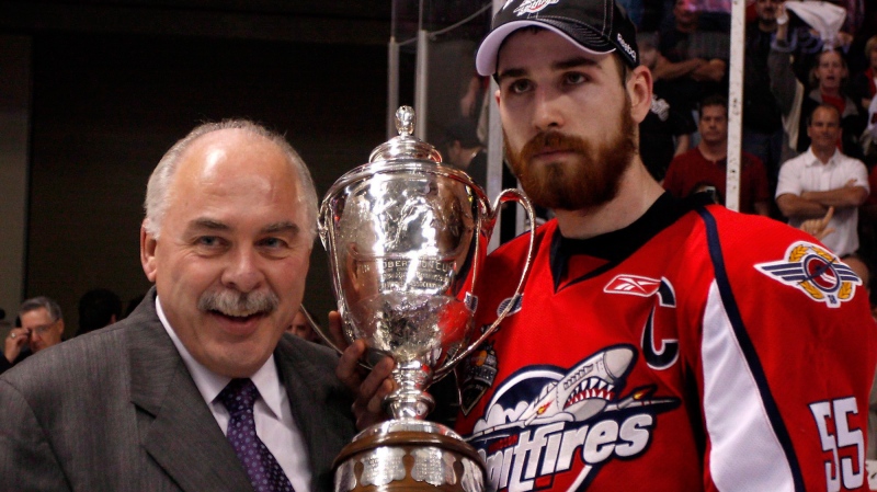 Windsor Spitfires' Captain Harry Young, right, accepts the J. Ross Robertson Trophy from Commissioner David Branch, left, after defeating the Barrie Colts' for the OHL championship on Tuesday, May 4, 2010 in Windsor, Ont. THE CANADIAN PRESS/Greg Plante