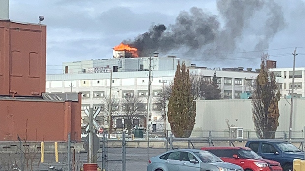 Flames and smoke are seen atop the former McCormick/Beta Brands factory in east London, Ont. on Tuesday, Nov. 20, 2018. (Source: Logan Predy)