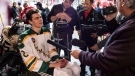 Humboldt Broncos hockey players Jacob Wassermann, left, talks to reporters after skating in an exhibition sled hockey game with teammate Ryan Straschnitzki, not shown, at a University of Denver and Providence college hockey game at Magness Arena in Denver on Friday, Nov. 23, 2018. (Joe Mahoney/Canadian Press)