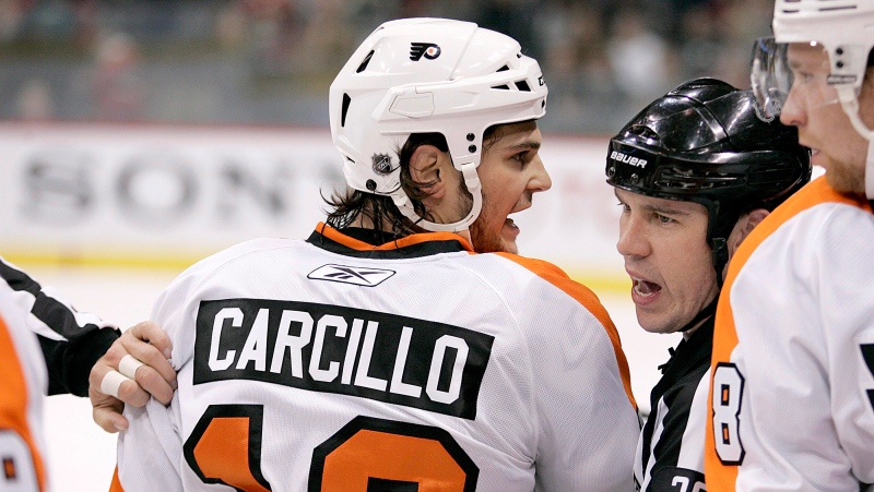 Philadelphia Flyers left wing Daniel Carcillo is restrained by referee Ian Walsh (29) in the first period against the Minnesota Wild during a preseason NHL hockey game in St. Paul, Minn., on September 25, 2010. (THE CANADIAN PRESS/AP, Andy King)