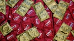 This Feb. 14, 2013 file photo, a sample of condoms is displayed at a news conference in Los Angeles. (AP Photo/Damian Dovarganes, File)