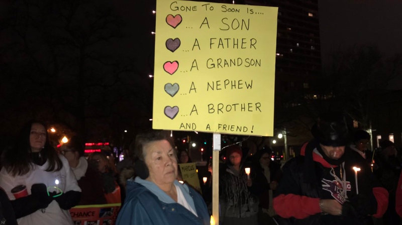 A woman holds a sign at a vigil to remember the victims of violence on November 28, 2018. ( Alana Hadadean / CTV Windsor )