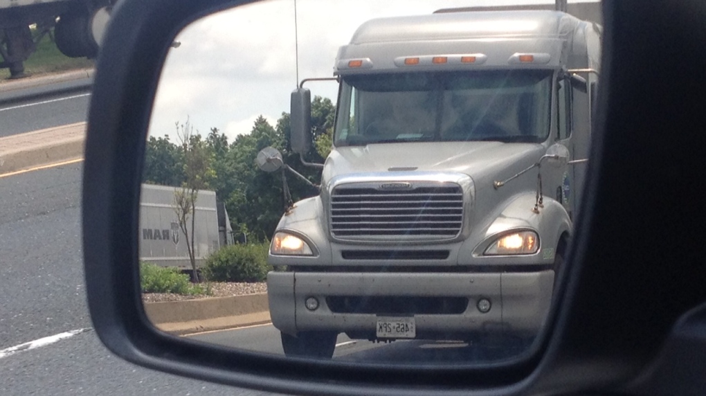 A transport truck in a side mirror