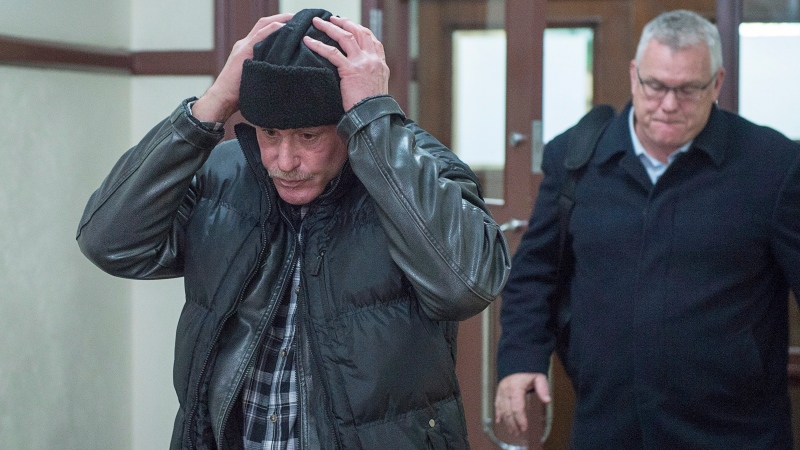 Joseph (Patrice) Simard, left, adjusts his hat as he heads from provincial court in Halifax on Wednesday, Dec. 5, 2018. Const. Laurence Gary Basso faces charges of assault and falsifying information in police reports relating to the alleged assault of Simard at a homeless shelter. (THE CANADIAN PRESS/Andrew Vaughan)