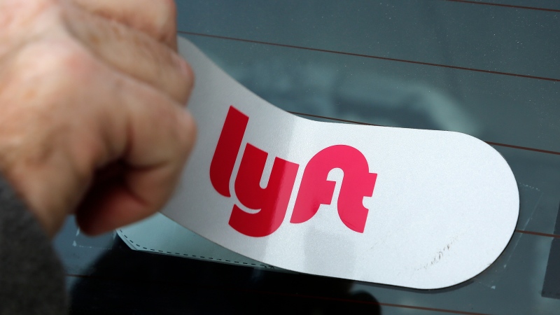 In this Jan. 31, 2018, file photo, a Lyft logo is installed on a Lyft driver's car in Pittsburgh. (AP Photo/Gene J. Puskar, File)