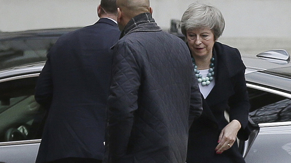 Theresa May, right, arrives at 10 Downing Street