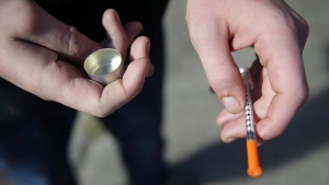 In this Oct. 22, 2018 file photo, a fentanyl user holds a needle in Philadelphia. (David Maialetti/The Philadelphia Inquirer via AP, File)