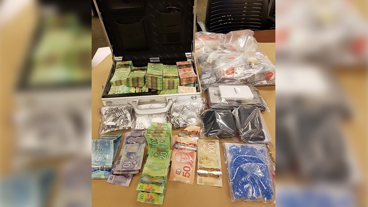 Cash and drugs seized in a raid on Wednesday, Dec. 19, 2018 are seen in London, Ont. (Source: London Police Service)