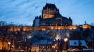 The Chateau Frontenac is illuminated with Christmas colors in the old historic area of Quebec City, Sunday, Dec. 16, 2018. THE CANADIAN PRESS/Jacques Boissinot